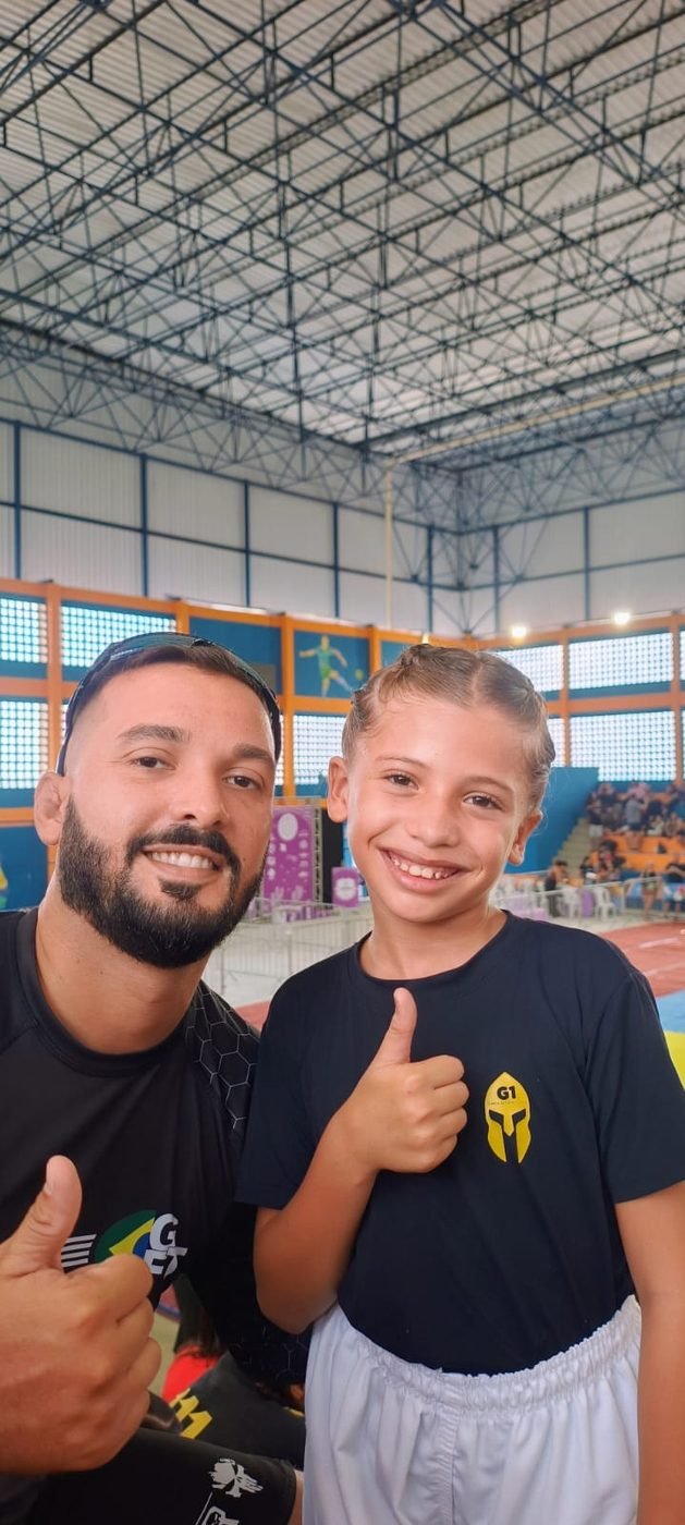 Professor e aluna em campeonato de Jiu-Jitsu